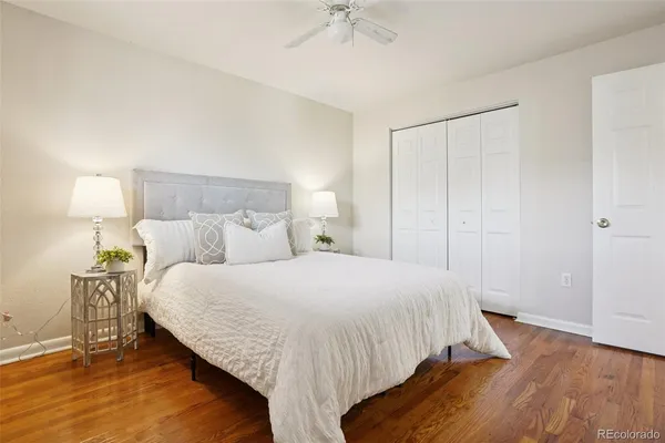 a bedroom with a bed and a ceiling fan