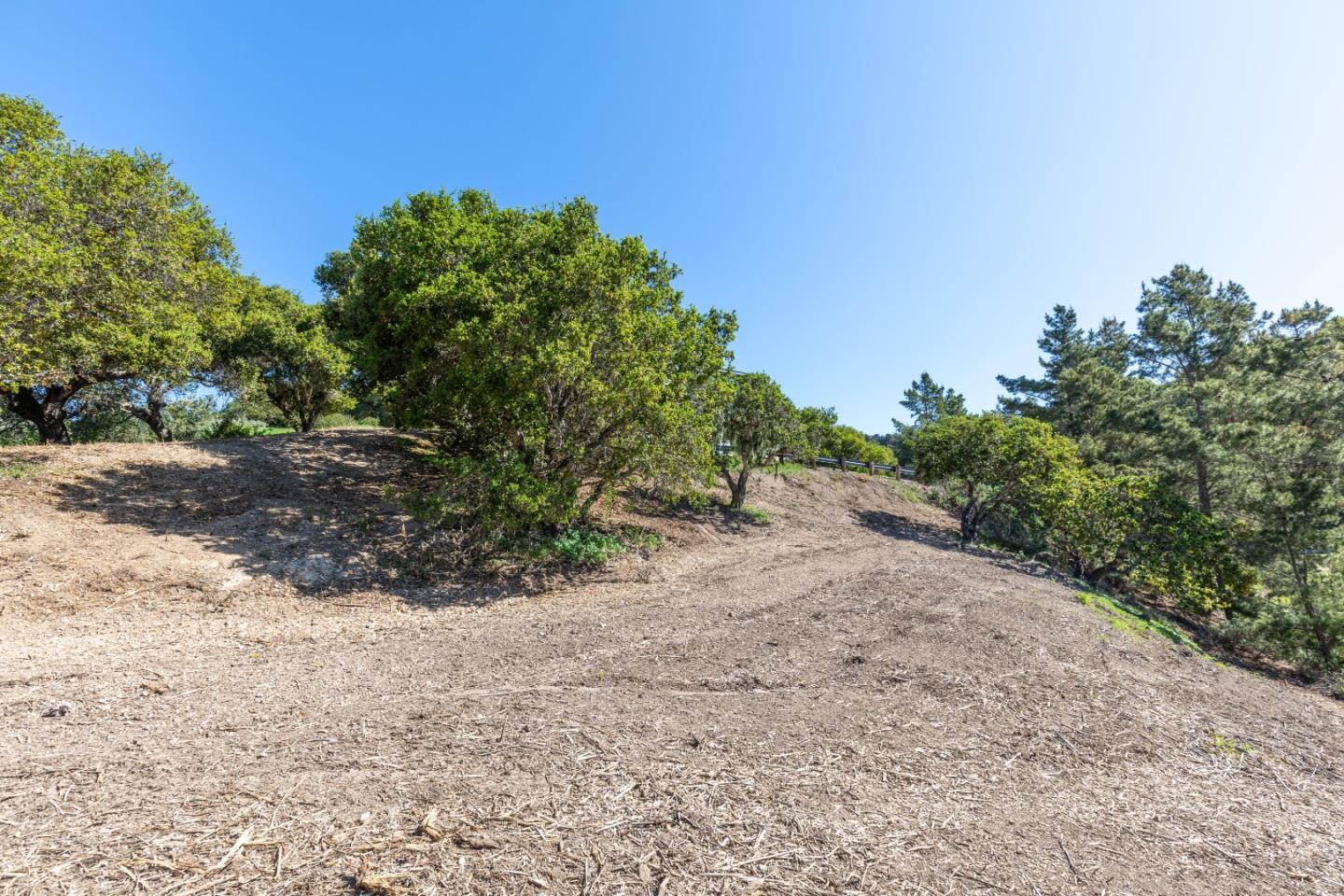 28007 Mercurio Road Carmel, CA 93923 - Photo 17 of 21 a view of a dirt road with a building in the background