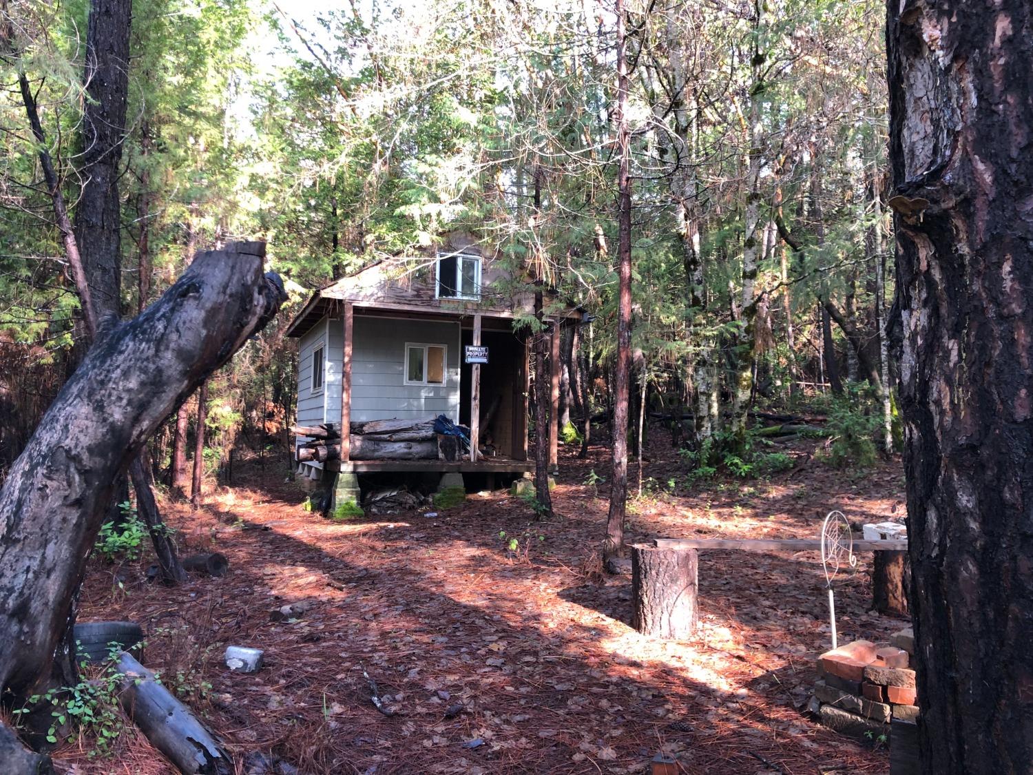 0 Whispering Pines Challenge, CA 95925 - Photo 10 of 22 a view of a wooden house with a tree in the forest