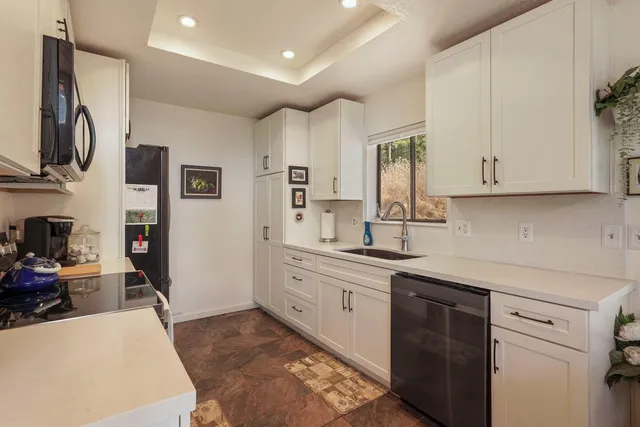 a kitchen with a refrigerator and a sink