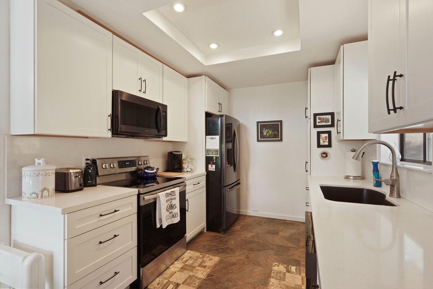 402 Rabbit's Foot Road West Point, CA 95255 - Photo 13 of 65 a kitchen with stainless steel appliances a refrigerator stove microwave and sink
