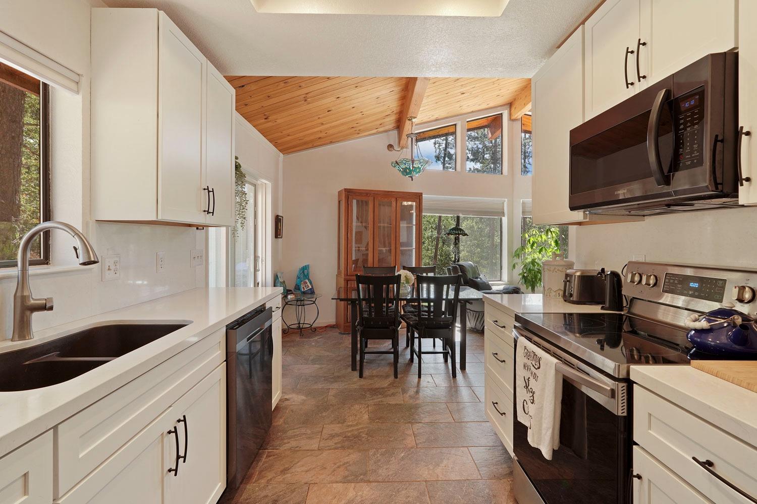402 Rabbit's Foot Road West Point, CA 95255 - Photo 15 of 65 a kitchen with stainless steel appliances a stove sink microwave and cabinets