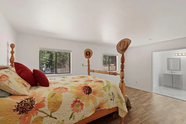 a spacious bathroom with a double vanity sink a mirror and a