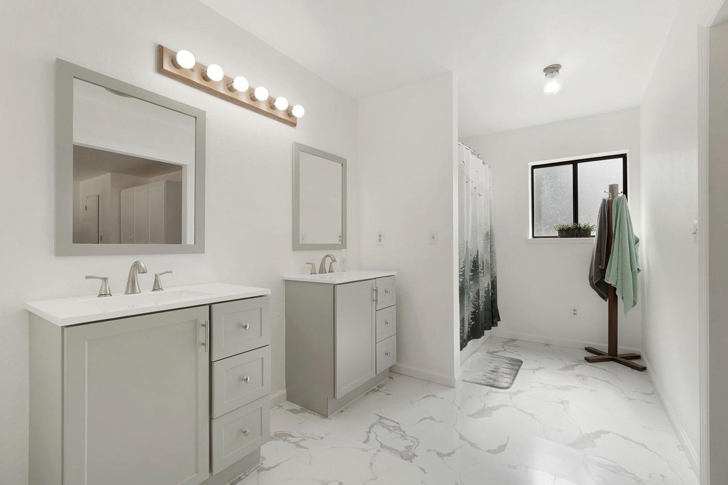 402 Rabbit's Foot Road West Point, CA 95255 - Photo 18 of 65 a spacious bathroom with a toilet sink and mirror