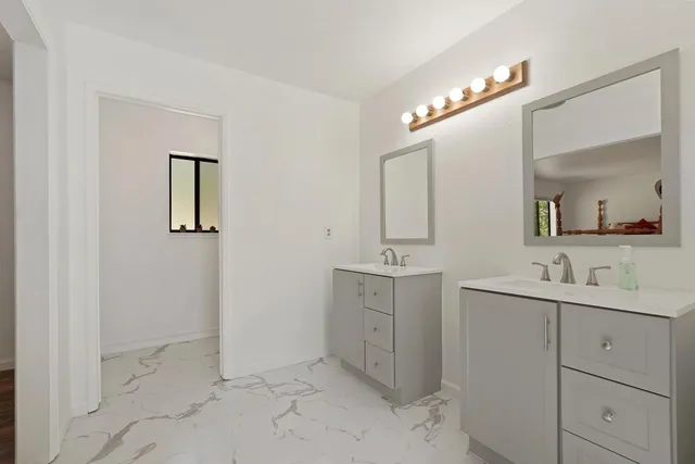 a view of entryway and hall with wooden floor