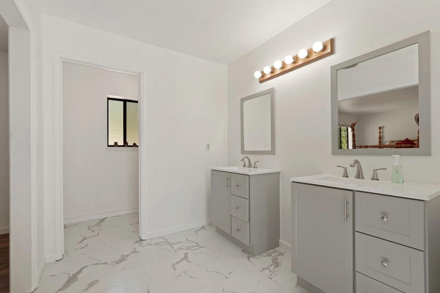 402 Rabbit's Foot Road West Point, CA 95255 - Photo 19 of 65 a spacious bathroom with a double vanity sink a mirror and a