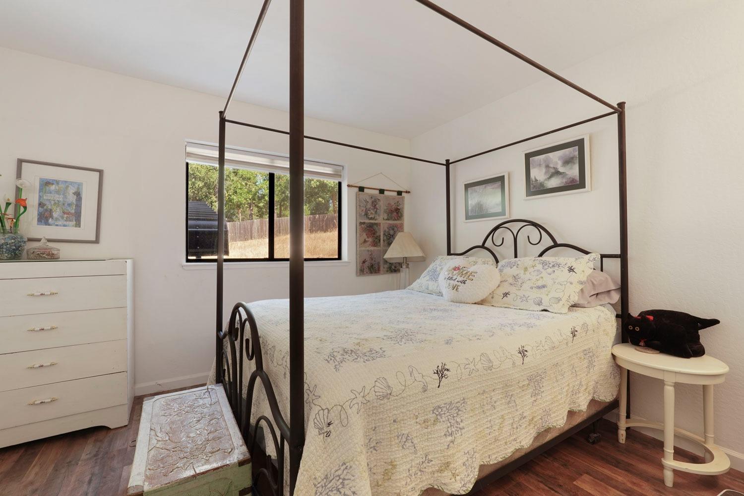 402 Rabbit's Foot Road West Point, CA 95255 - Photo 23 of 65 a bedroom with a bed a mirror and a window