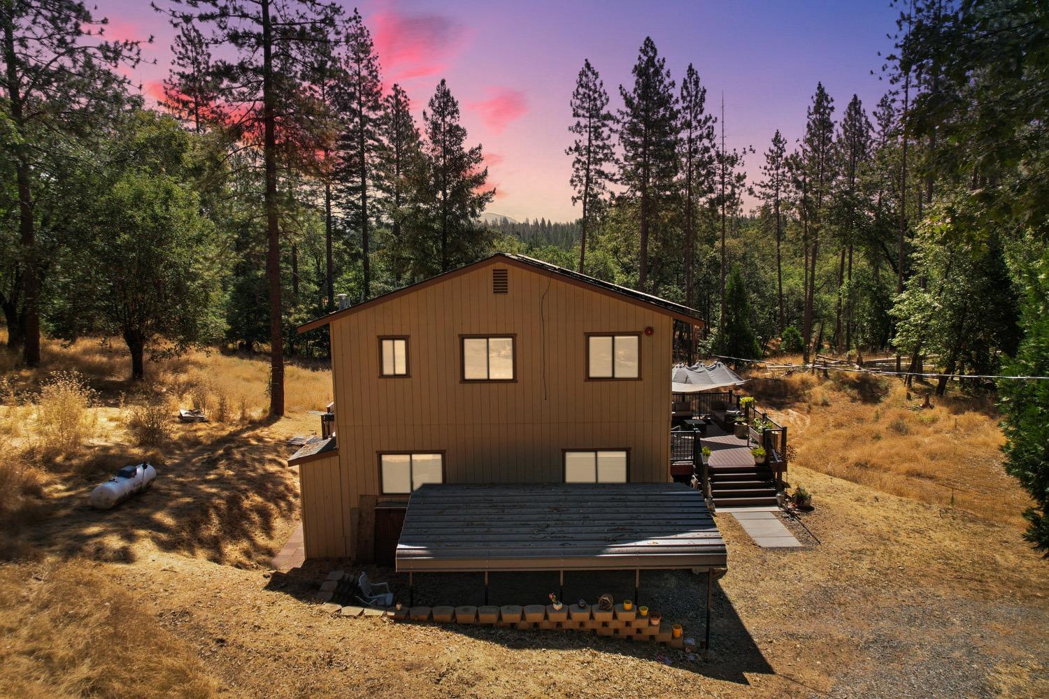 402 Rabbit's Foot Road West Point, CA 95255 - Photo 30 of 65 a view of a house with a yard covered in snow