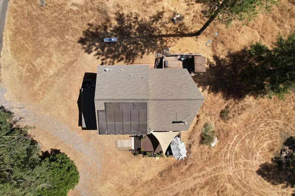 a view of a house with backyard and sitting area