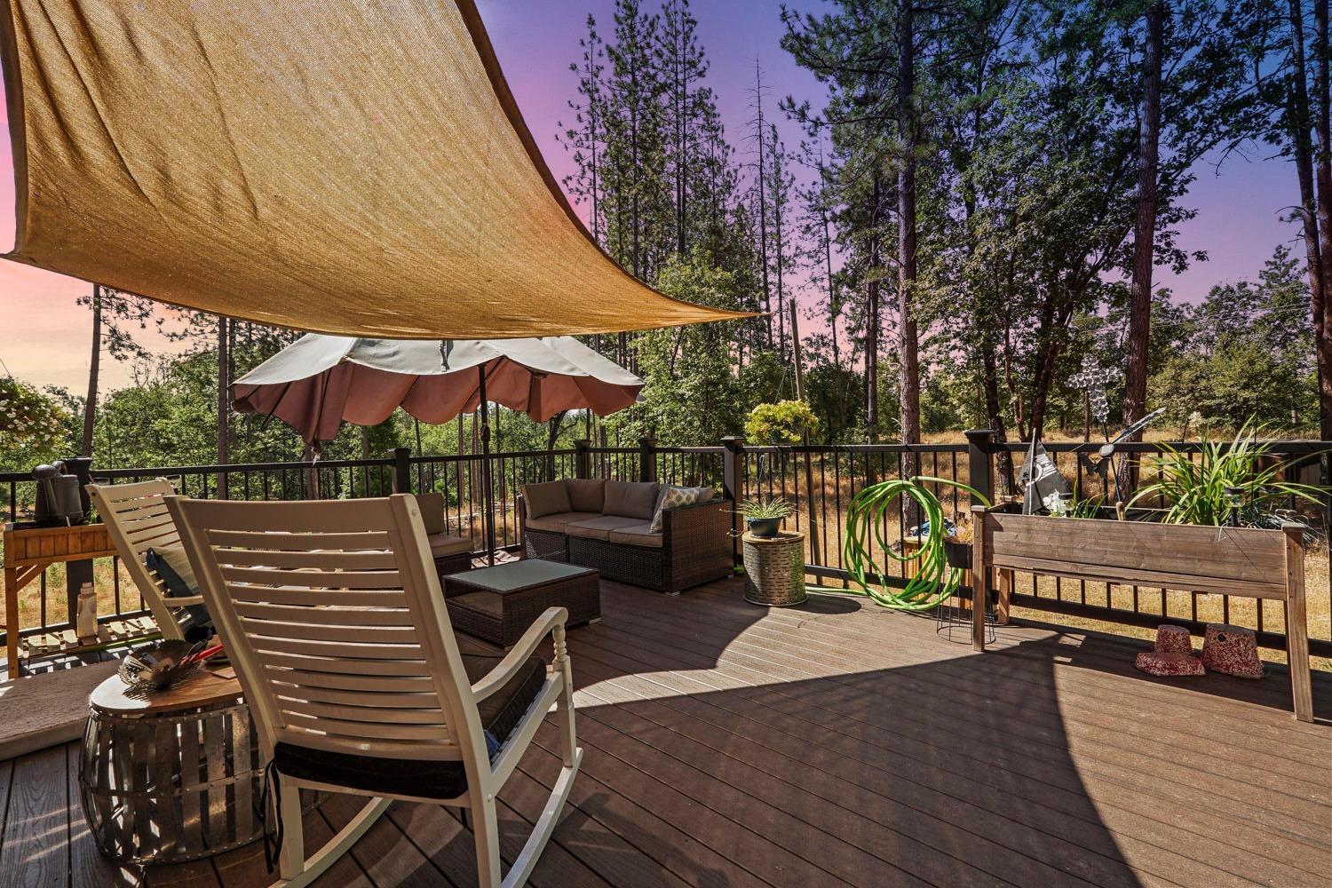 402 Rabbit's Foot Road West Point, CA 95255 - Photo 6 of 65 a view of a patio with table and chairs with wooden floor and fence