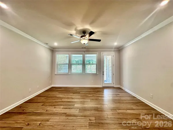 a view of empty room with wooden floor