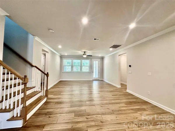 a large kitchen with granite countertop a lot of counter space and wooden floor