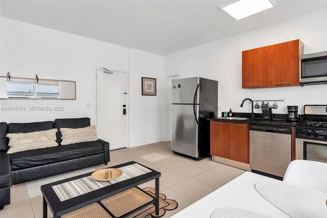 a kitchen with stainless steel appliances granite countertop a refrigerator and a stove top oven