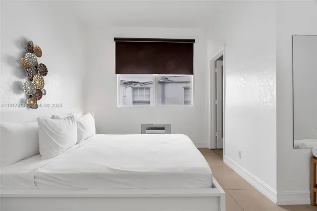 a large white bed in a white room