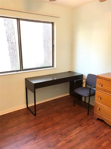 a reading room with furniture and a window