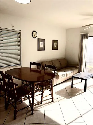 a living room with furniture a table and a window