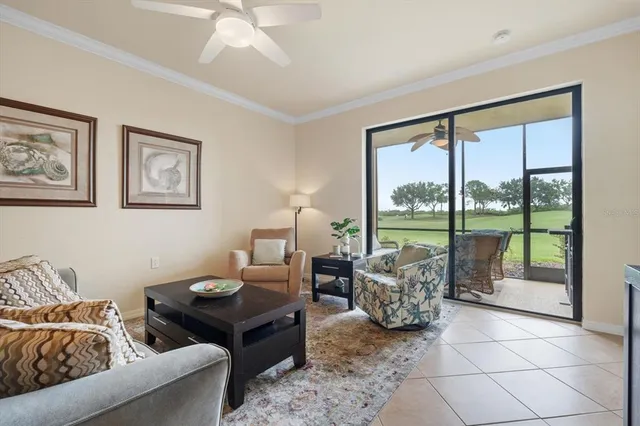a living room with furniture and large windows