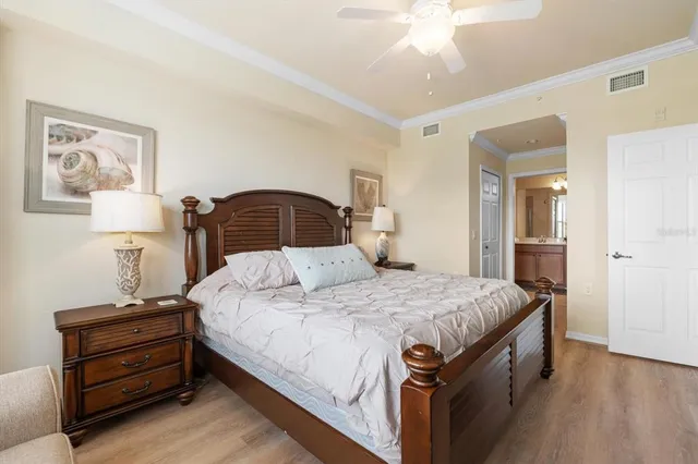 a bedroom with a bed and a chandelier