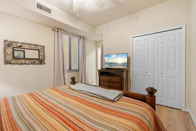 a bedroom with a bed and a tv on the dresser