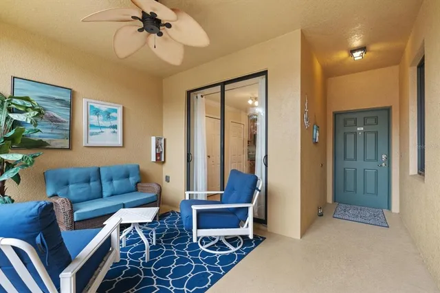 a living room with furniture and a view of bedroom