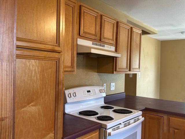 408 Ruth Street Kerrville, TX 78028 - Photo 5 of 12 a kitchen with a refrigerator stove and cabinets