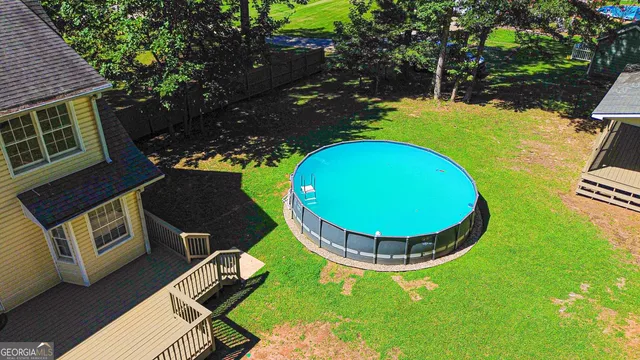 a kitchen with stainless steel appliances granite countertop a refrigerator a stove a sink a microwave and white cabinets