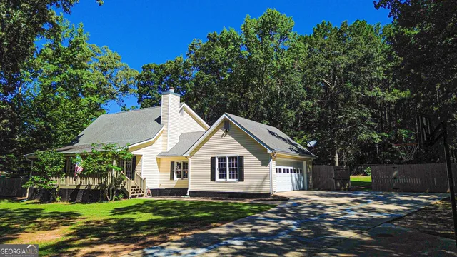 a living room with furniture a chandelier and a flat screen tv