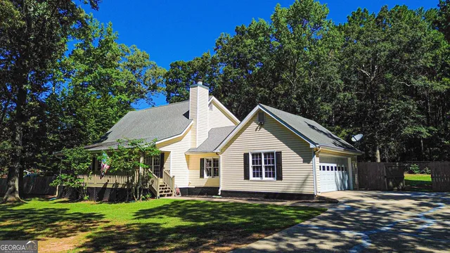a living room with furniture a flat screen tv and a window