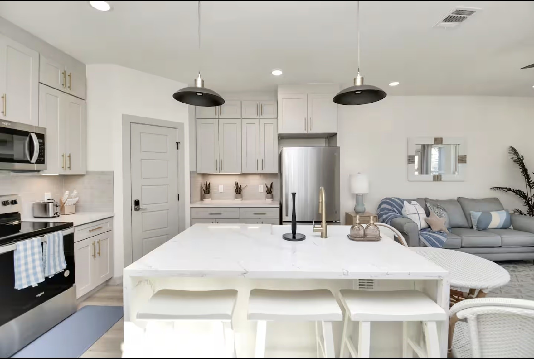442 6th Street Dickinson, TX 77539 - Photo 11 of 29 a kitchen with stainless steel appliances kitchen island granite countertop a refrigerator a stove a sink and white cabinets