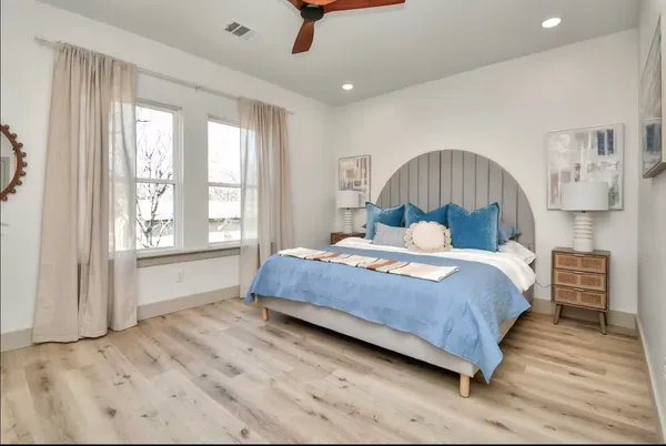 a bedroom with a large bed and a large window