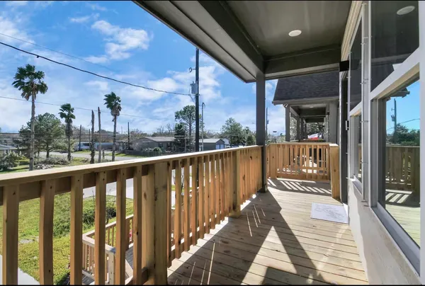 a view of a balcony with wooden floor