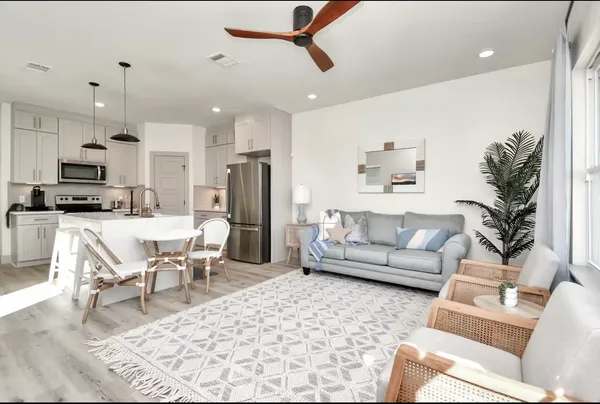 a living room with furniture and kitchen view