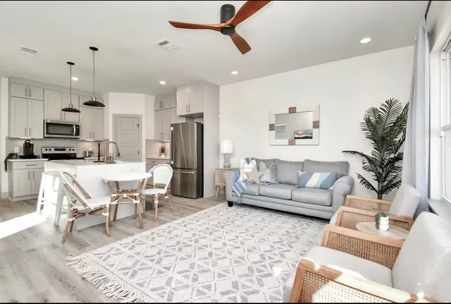 a living room with furniture and kitchen view