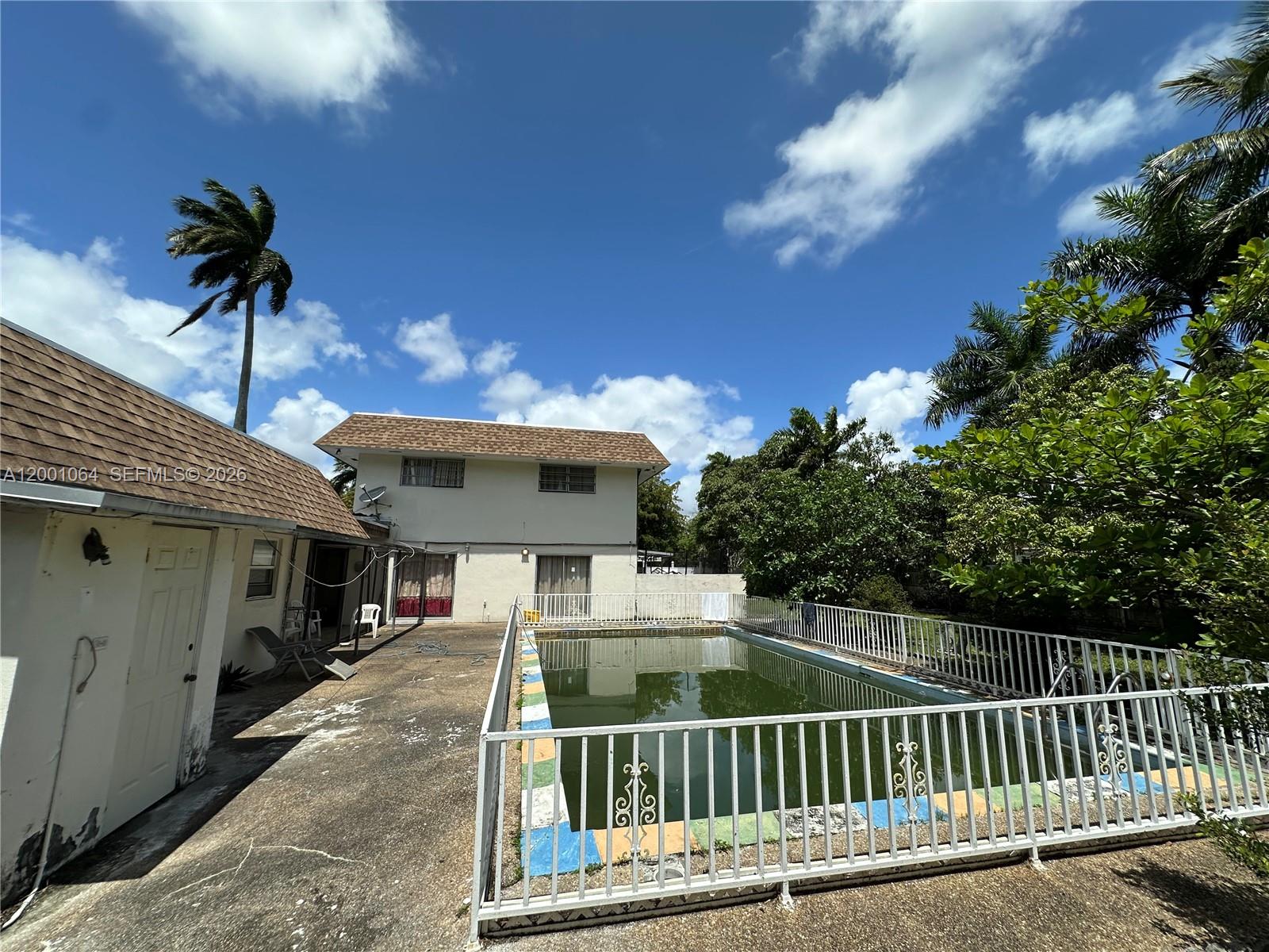 200 Northeast 158th Street Miami, FL 33162 - Photo 16 of 16 a view of a house with a balcony