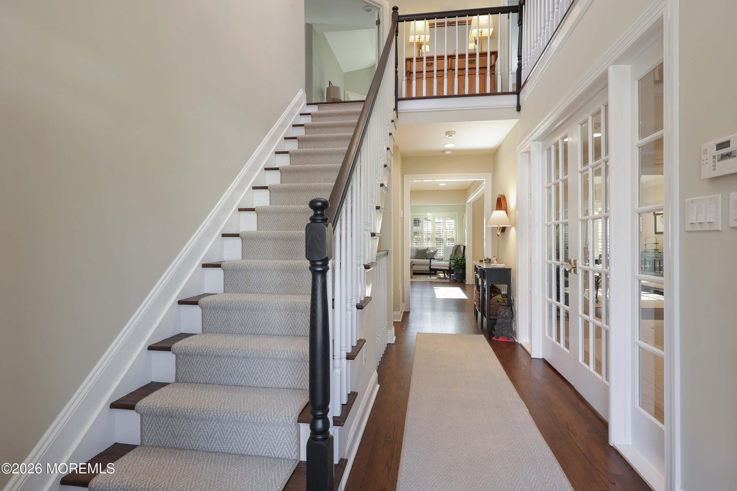 13 Country Lane Little Silver, NJ 07739 - Photo 19 of 42 a view of staircase with lots of frames on wall and a window