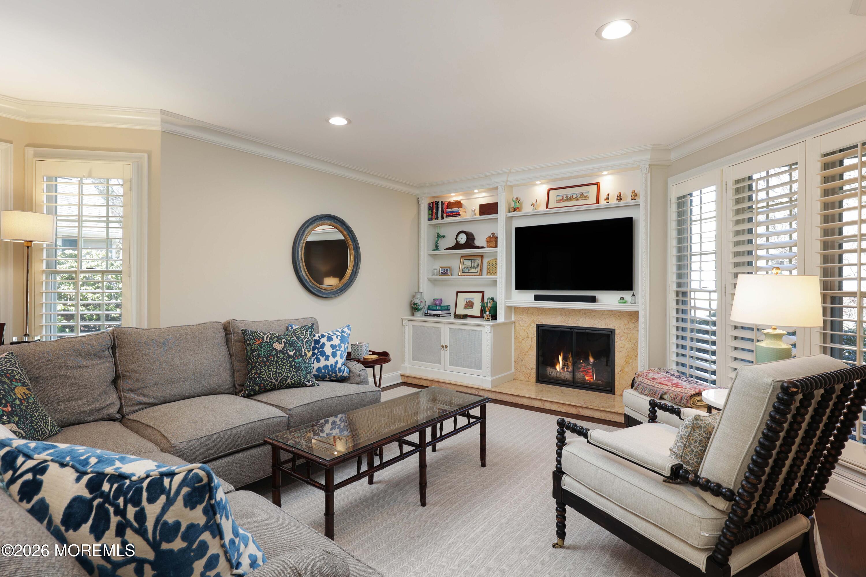 13 Country Lane Little Silver, NJ 07739 - Photo 3 of 42 a living room with furniture a flat screen tv and a fireplace