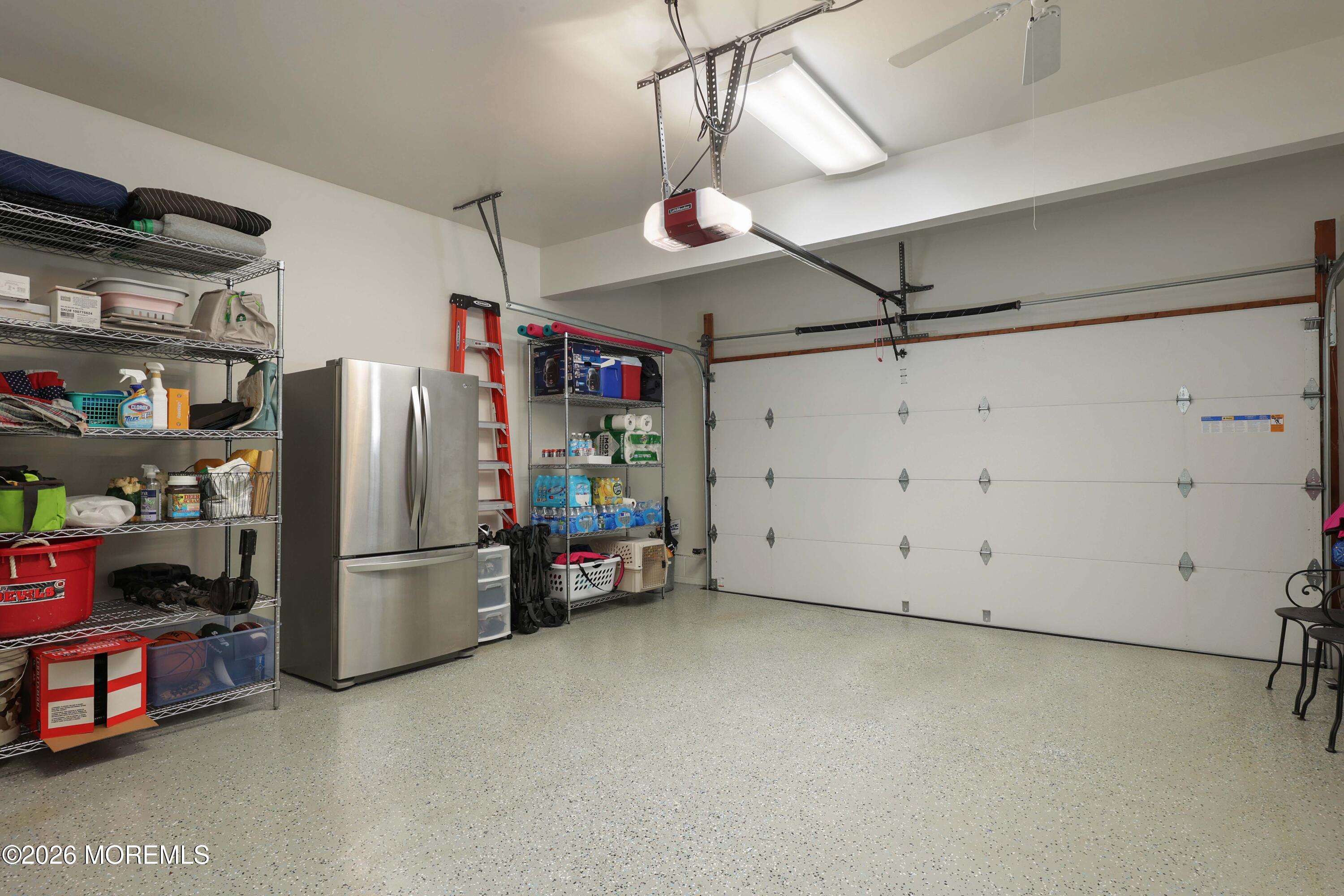 13 Country Lane Little Silver, NJ 07739 - Photo 35 of 42 a view of storage and utility room with refrigerator and toys