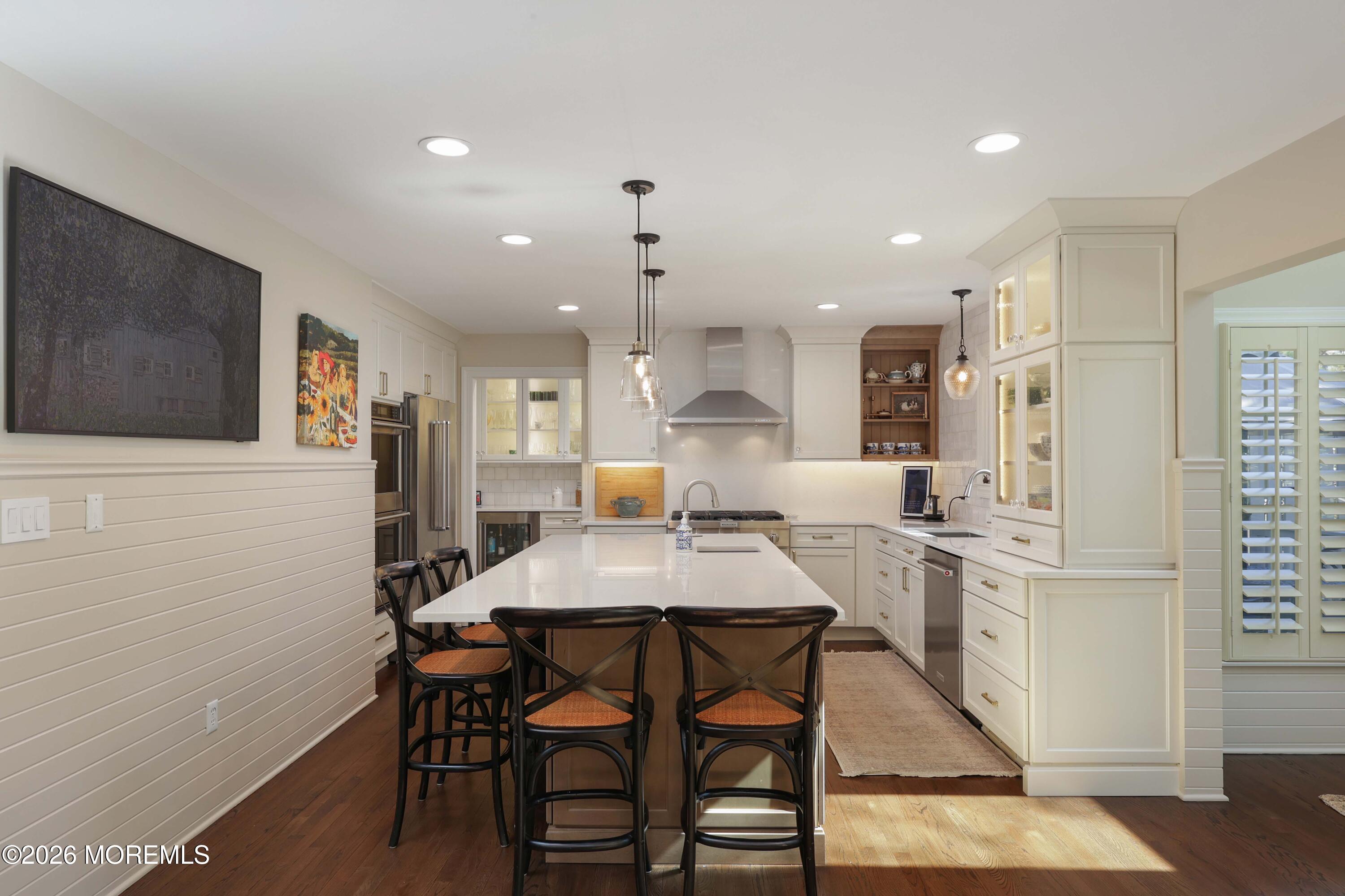 13 Country Lane Little Silver, NJ 07739 - Photo 9 of 42 a kitchen with stainless steel appliances kitchen island granite countertop a dining table chairs and a refrigerator