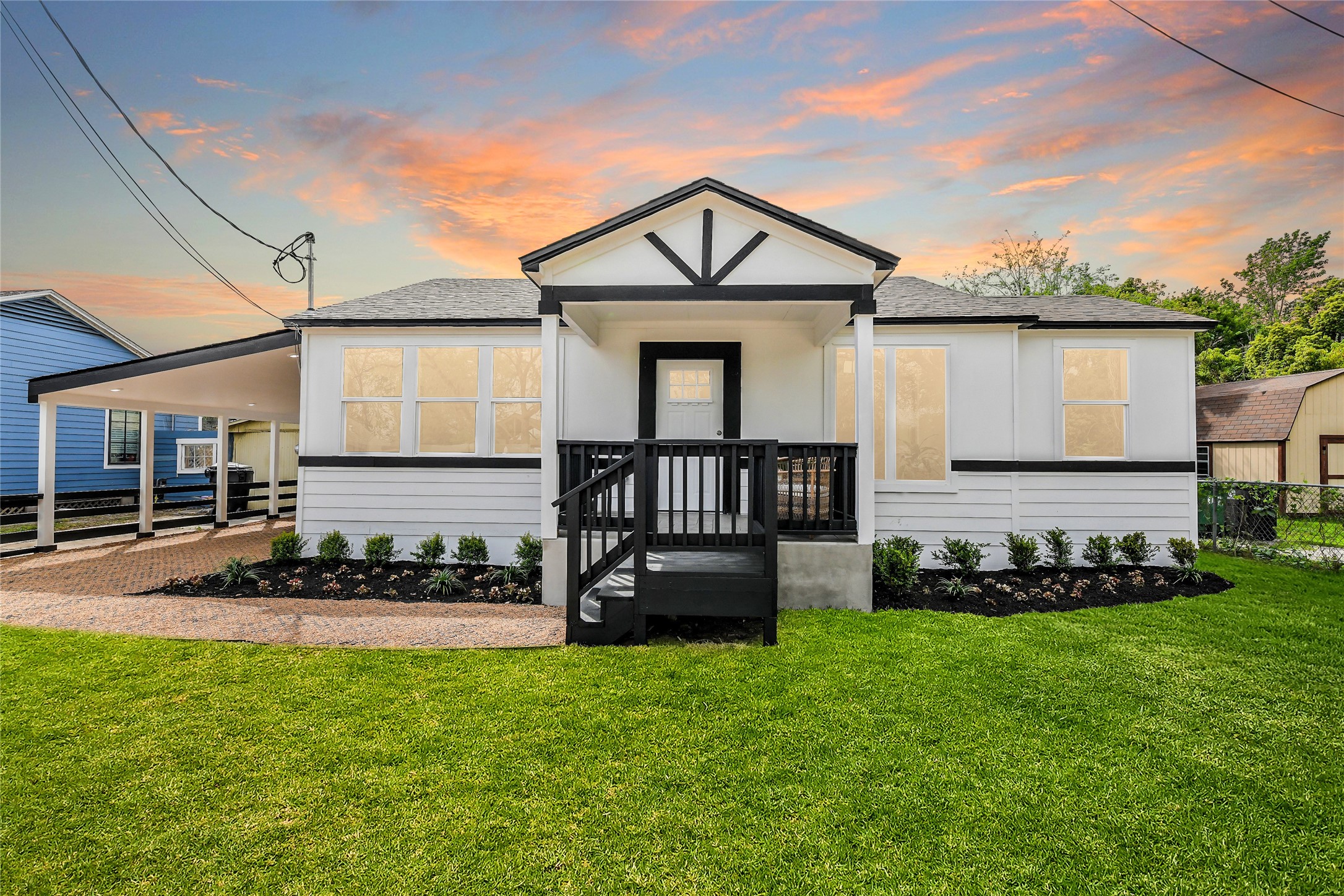 a front view of a house with a small yard and potted plants