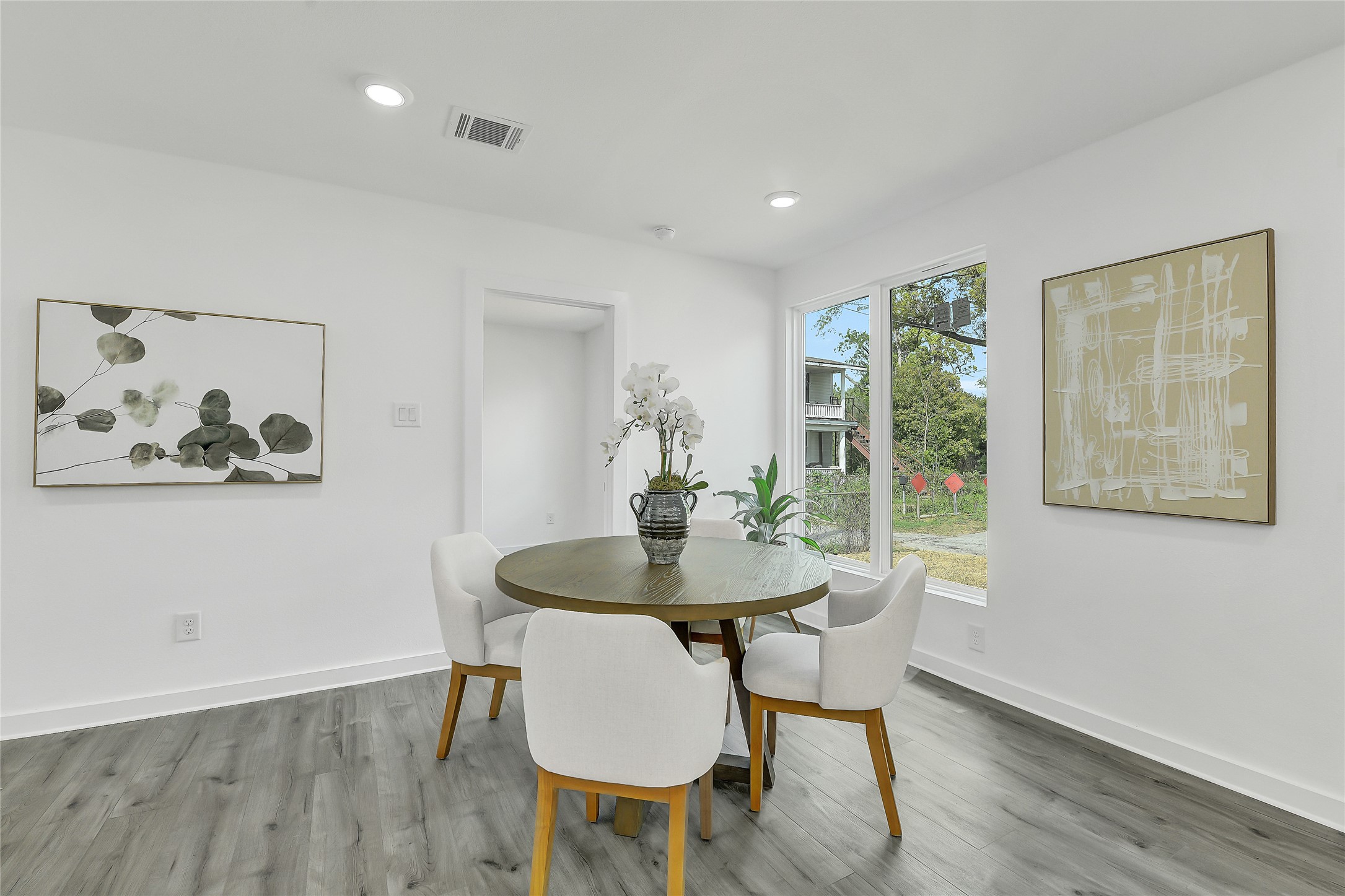 110 Harris Court Houston, TX 77009 - Photo 11 of 31 A versatile and airy dining space characterized by soft natural light and modern flooring that extends throughout the home.
