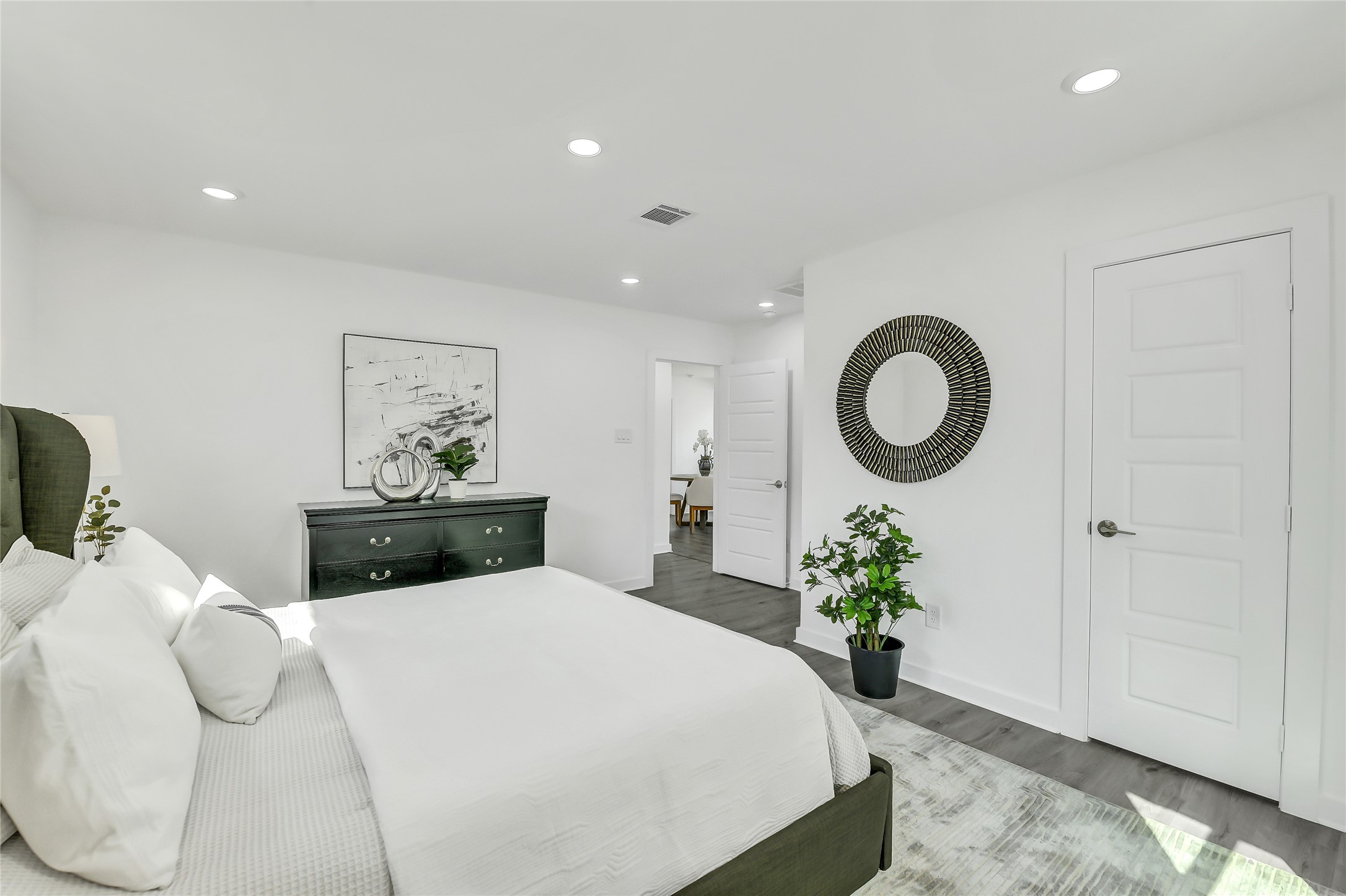110 Harris Court Houston, TX 77009 - Photo 18 of 31 a bedroom with a bed and a potted plant