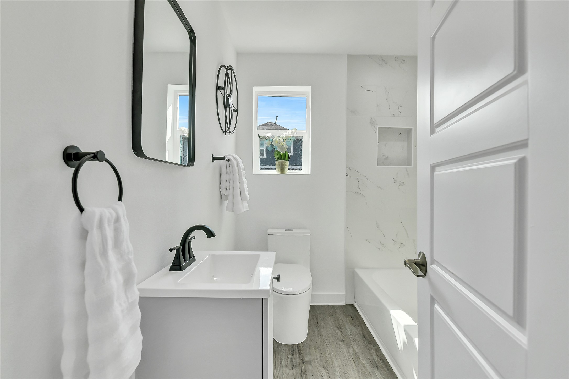 110 Harris Court Houston, TX 77009 - Photo 20 of 31 a bathroom with a sink and mirror with toilet