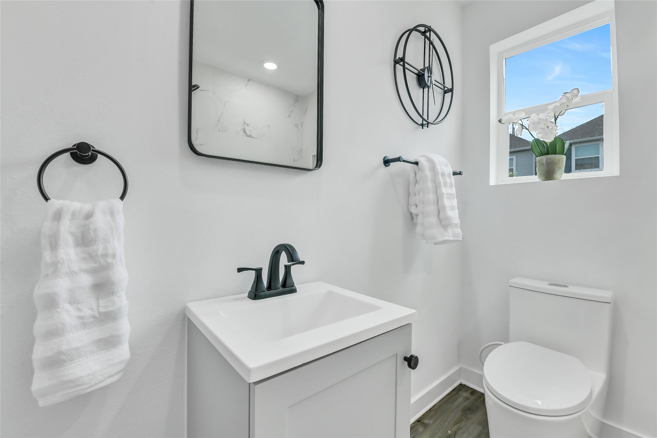 110 Harris Court Houston, TX 77009 - Photo 21 of 31 a bathroom with a toilet sink vanity and mirror