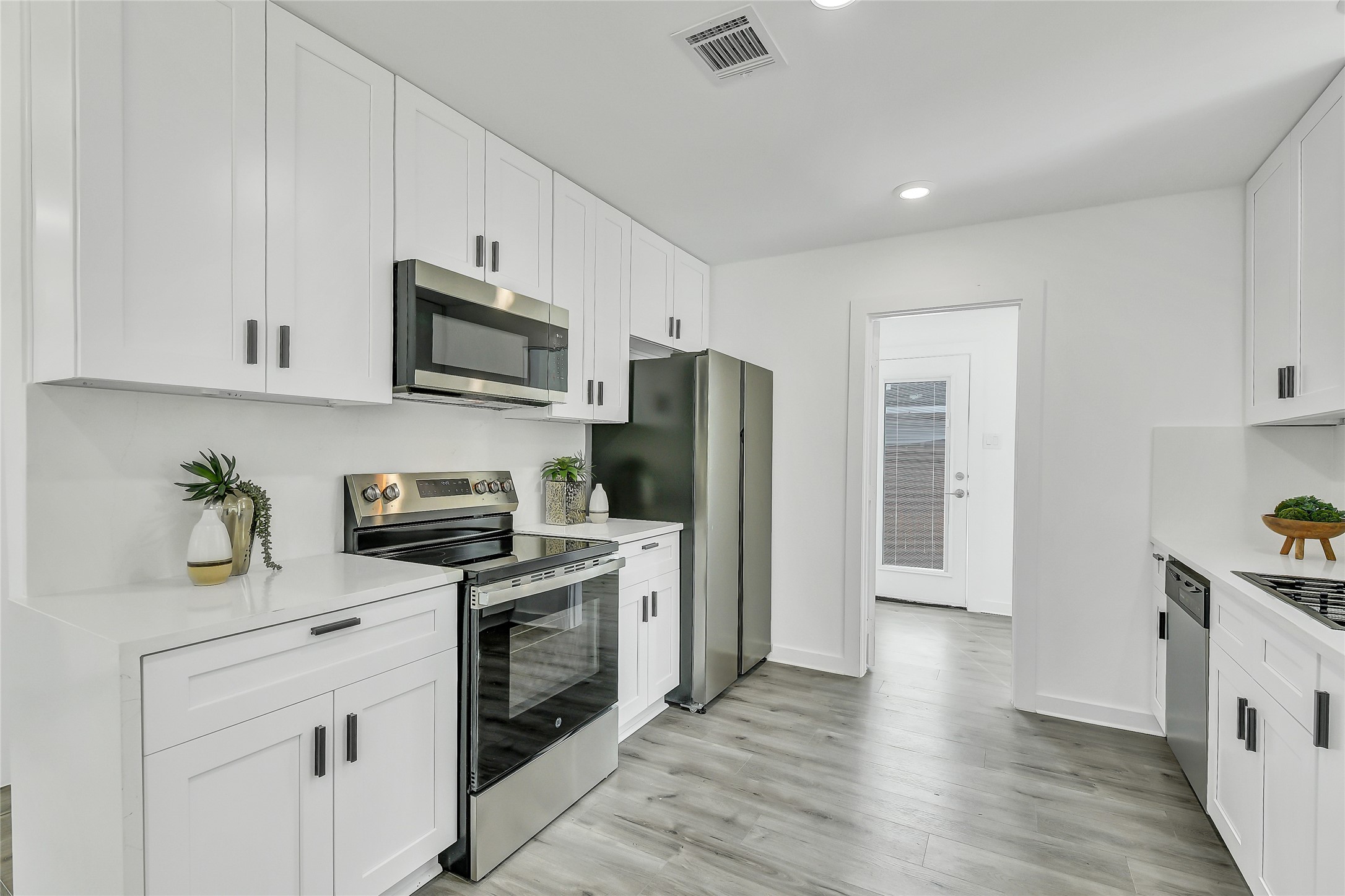 110 Harris Court Houston, TX 77009 - Photo 7 of 31 a kitchen with stainless steel appliances a stove microwave and refrigerator