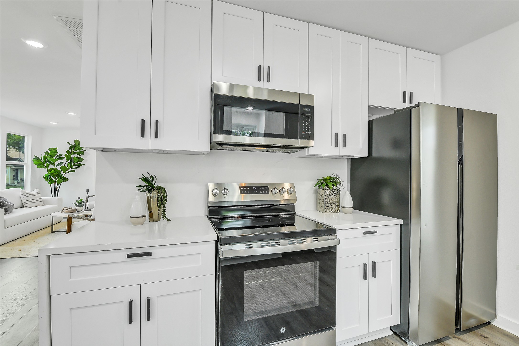 110 Harris Court Houston, TX 77009 - Photo 8 of 31 a kitchen with stainless steel appliances white cabinets and a stove a refrigerator a sink