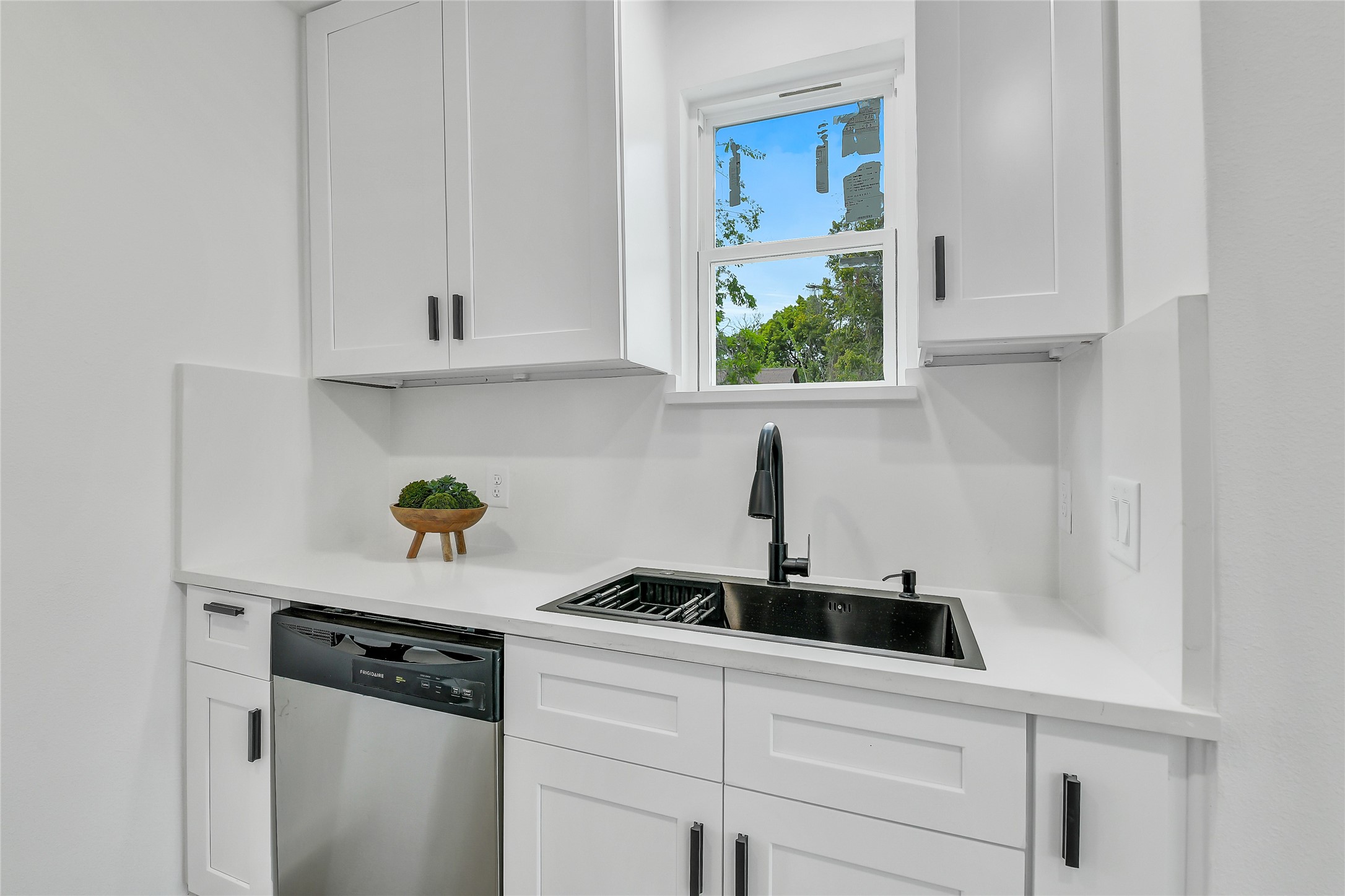 110 Harris Court Houston, TX 77009 - Photo 9 of 31 a kitchen with stainless steel appliances a sink a stove and a window
