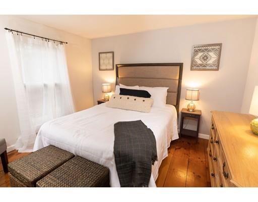 107 Groton School Road Ayer, MA 01432 - Photo 19 of 25 a bedroom with a bed and a painting on the wall