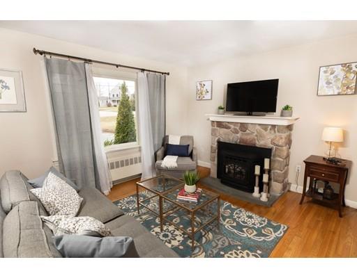 107 Groton School Road Ayer, MA 01432 - Photo 4 of 25 a living room with furniture a flat screen tv and a fireplace