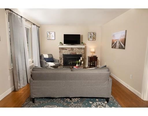 107 Groton School Road Ayer, MA 01432 - Photo 6 of 25 a living room with furniture a flat screen tv and a fireplace