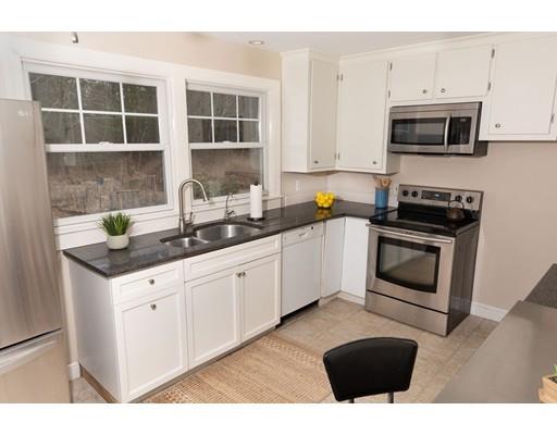 107 Groton School Road Ayer, MA 01432 - Photo 7 of 25 a kitchen with stainless steel appliances granite countertop a stove a sink and a microwave
